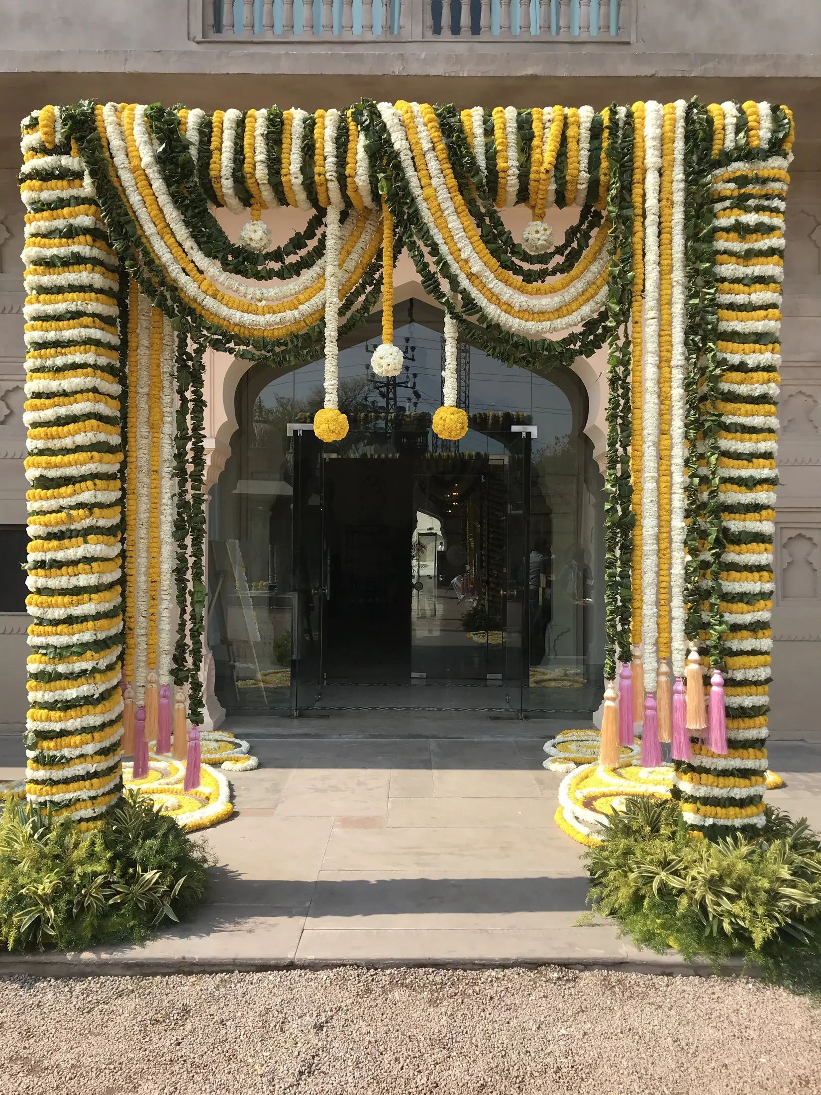 Entrance gateway decorated with garlands of yellow and white marigolds